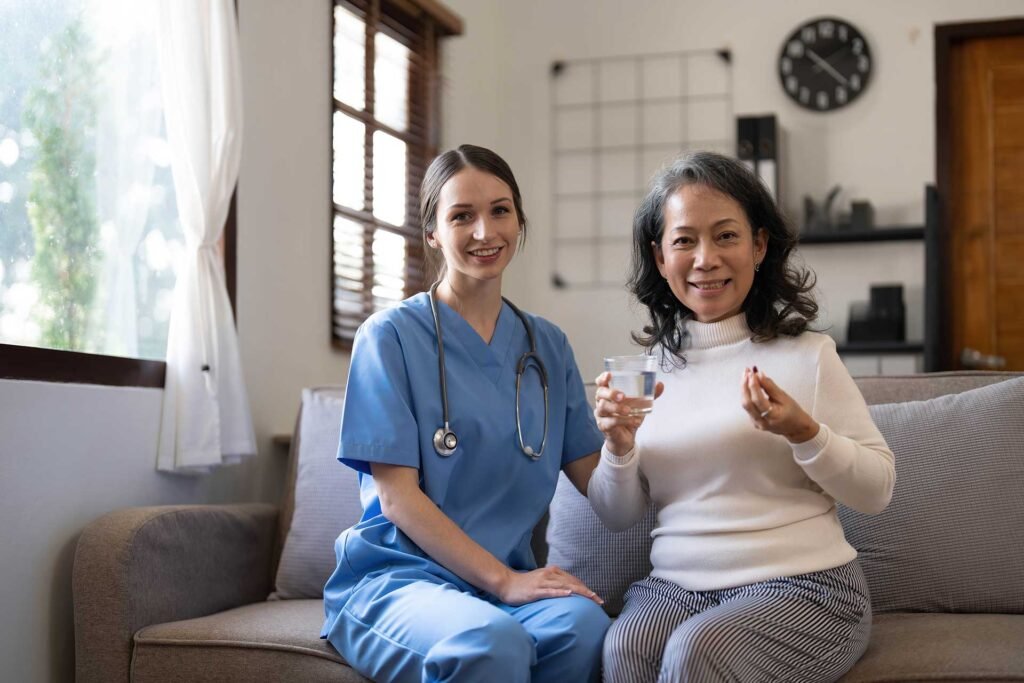 asian-nurse-showing-health-checkup-report-to-grand-HZ356JB.jpg